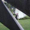 Couple posing in front of Spoonbridge and Cherry through Nautilus