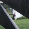 Couple posing in front of Spoonbridge and Cherry through Nautilus